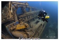 At a depth of about 70-feet, a diver pauses for a moment ... by Michael Grebler 